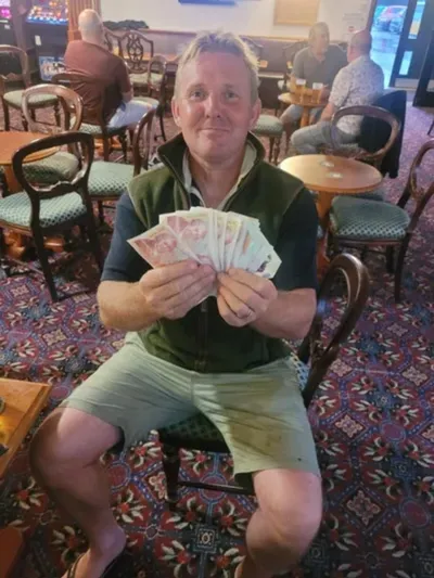 A winner of the cash prize draw at Redlynch Social Club